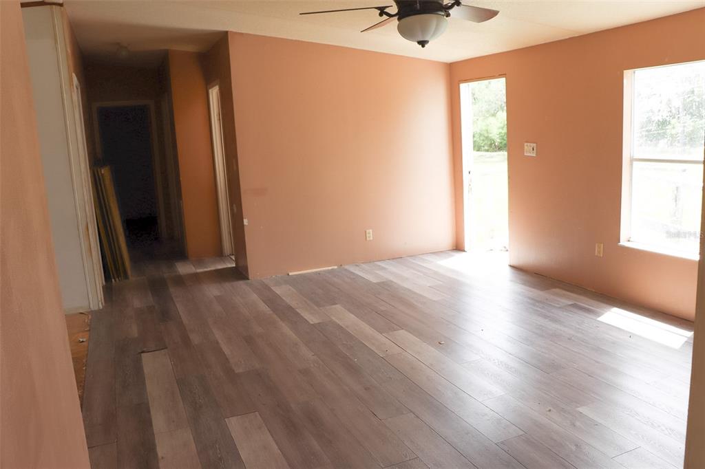 448 Fernandez Street Winter Haven, FL 33880 - Photo 8 of 27 an empty room with wooden floor and windows