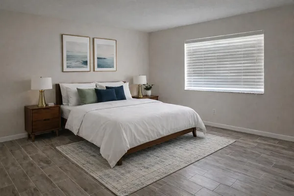 a bedroom with a bed and wooden floor