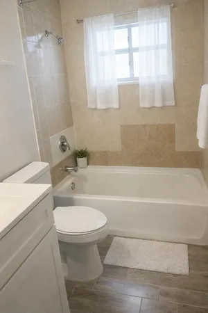 a bathroom with a sink a window and a toilet