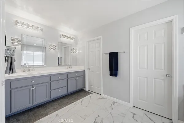 a spacious bathroom with a tub shower and windows