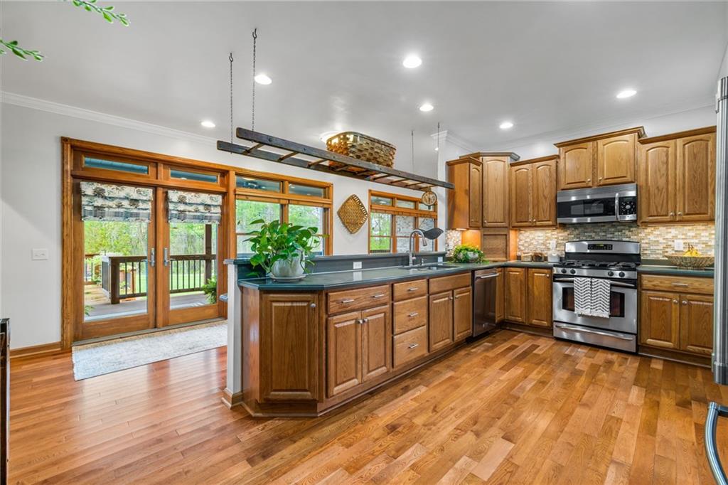 764 Old Millcreek Road Hookstown, PA 15050 - Photo 8 of 48 a kitchen with stainless steel appliances granite countertop a stove and a wooden floors