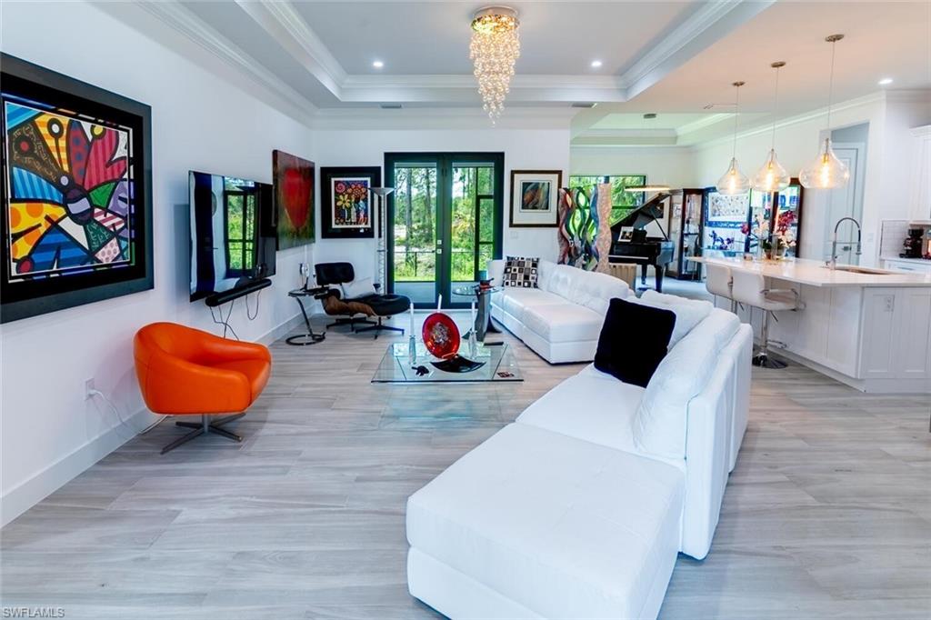 2572 Randall Boulevard Naples, FL 34120 - Photo 11 of 45 a living room with furniture and wooden floor