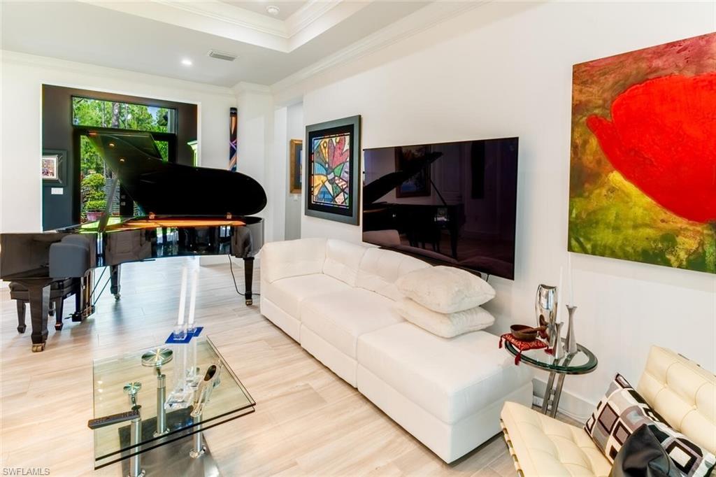 2572 Randall Boulevard Naples, FL 34120 - Photo 14 of 45 a living room with furniture and a flat screen tv