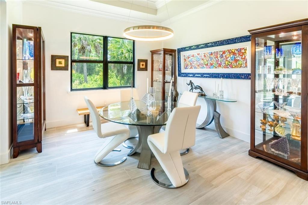 2572 Randall Boulevard Naples, FL 34120 - Photo 20 of 45 a dining room with furniture and a floor to ceiling window