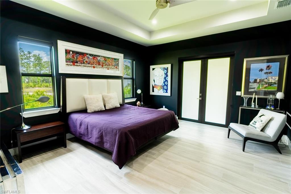 2572 Randall Boulevard Naples, FL 34120 - Photo 21 of 45 a bedroom with a large bed and a large window