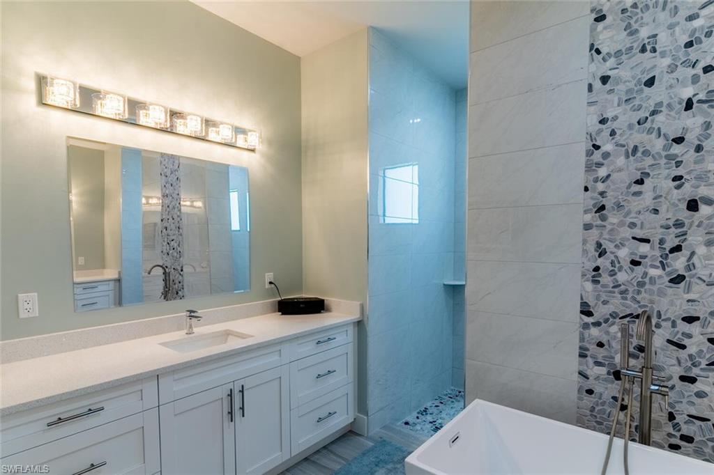 2572 Randall Boulevard Naples, FL 34120 - Photo 24 of 45 a bathroom with a sink a toilet and shower