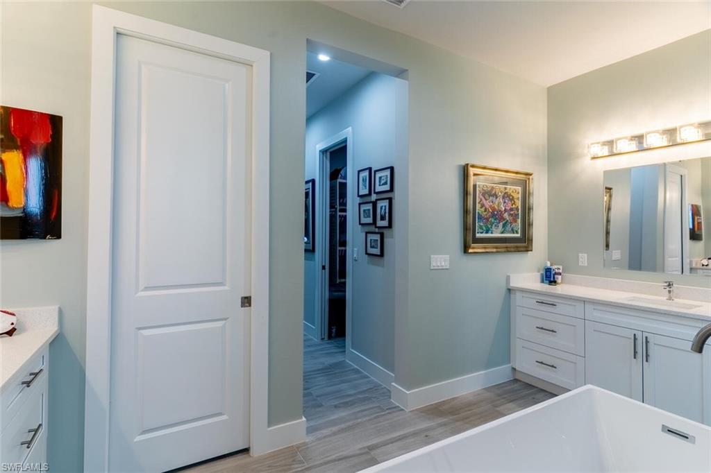 2572 Randall Boulevard Naples, FL 34120 - Photo 27 of 45 a view of a hallway with closet and wooden floor