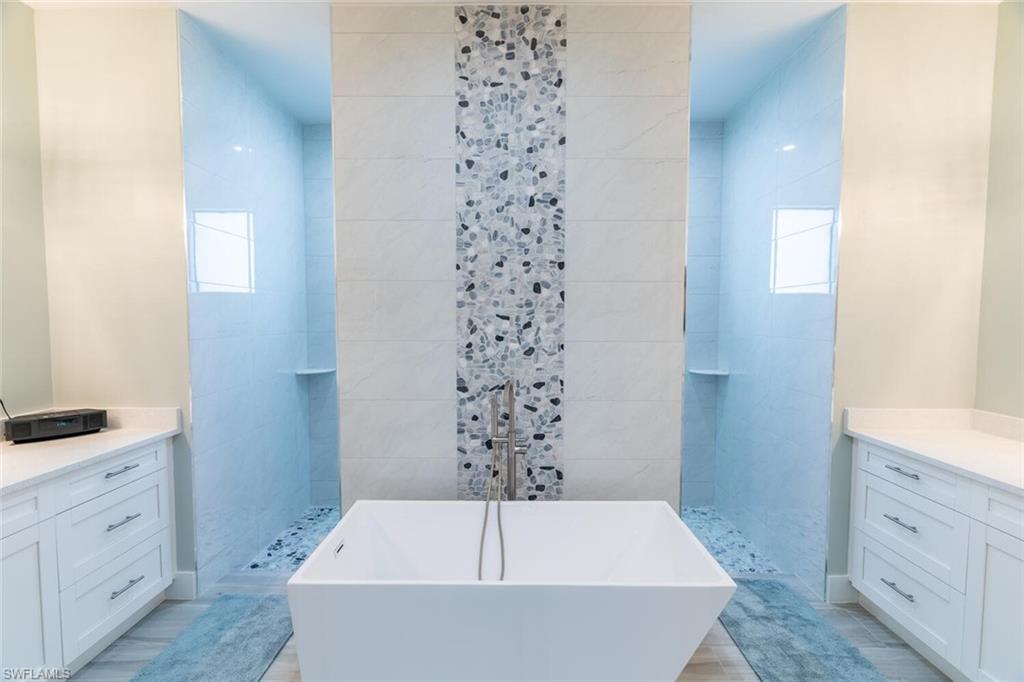 2572 Randall Boulevard Naples, FL 34120 - Photo 28 of 45 a bathroom with a bathtub and a sink