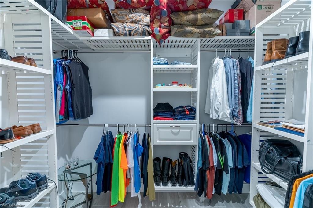 2572 Randall Boulevard Naples, FL 34120 - Photo 29 of 45 a view of walk in closet with clothes and shoes