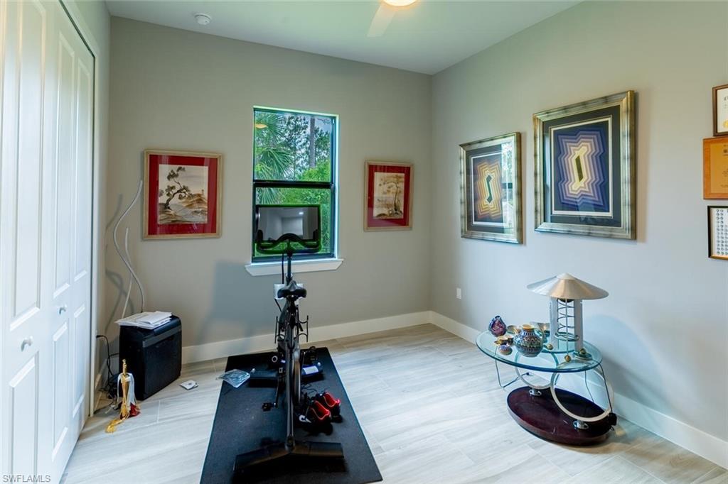 2572 Randall Boulevard Naples, FL 34120 - Photo 30 of 45 a room with furniture and a potted plant