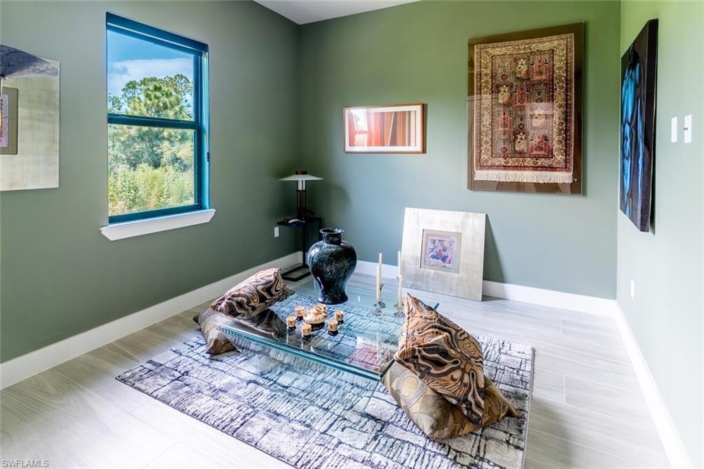 2572 Randall Boulevard Naples, FL 34120 - Photo 31 of 45 a bedroom with a bed and furniture