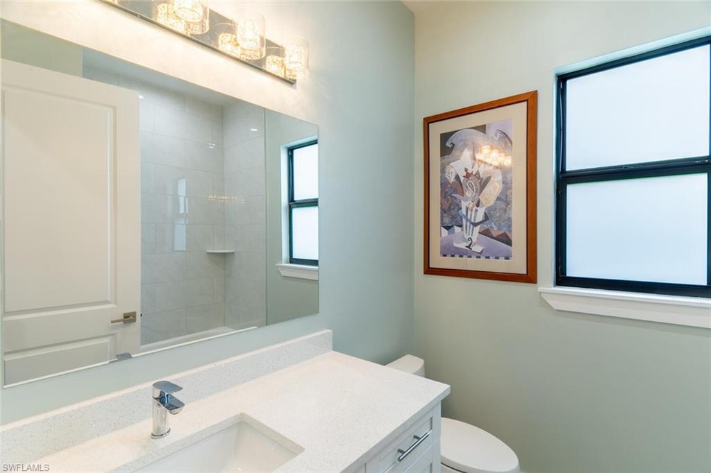 2572 Randall Boulevard Naples, FL 34120 - Photo 32 of 45 a bathroom with a sink and a mirror