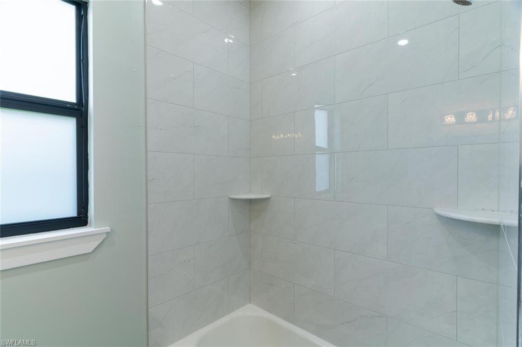 2572 Randall Boulevard Naples, FL 34120 - Photo 33 of 45 a bathroom with a shower