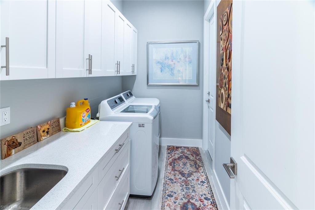 2572 Randall Boulevard Naples, FL 34120 - Photo 34 of 45 a utility room with sink dryer and washer