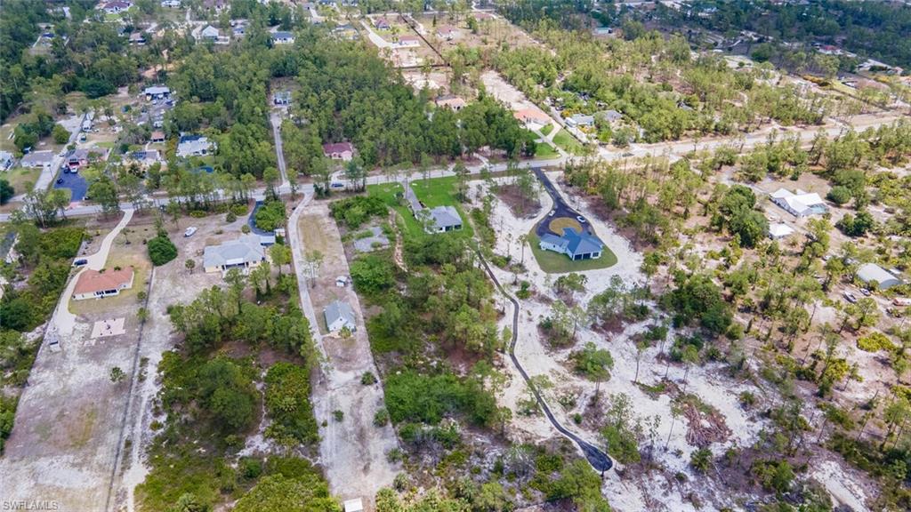 2572 Randall Boulevard Naples, FL 34120 - Photo 36 of 45 an aerial view of residential house with outdoor space and trees all around
