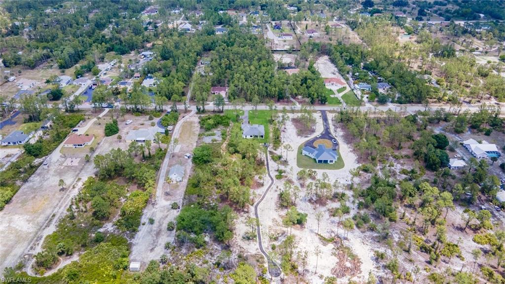 2572 Randall Boulevard Naples, FL 34120 - Photo 42 of 45 an aerial view of residential house with outdoor space and trees all around