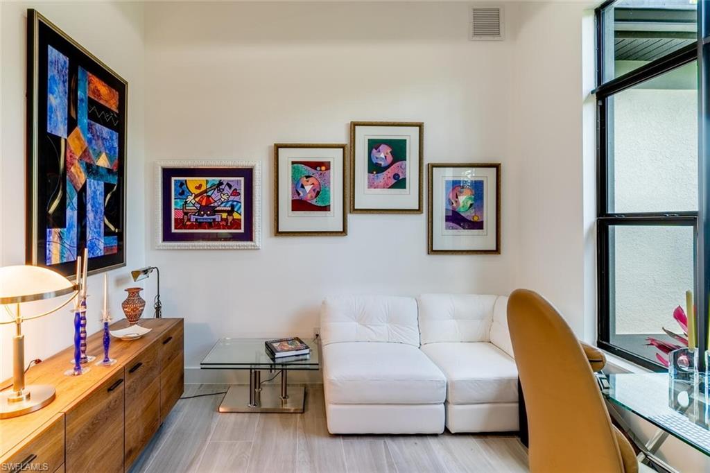 2572 Randall Boulevard Naples, FL 34120 - Photo 10 of 45 a living room with furniture and a flat screen tv