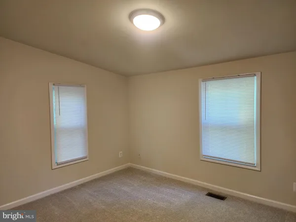an empty room with a empty space and windows