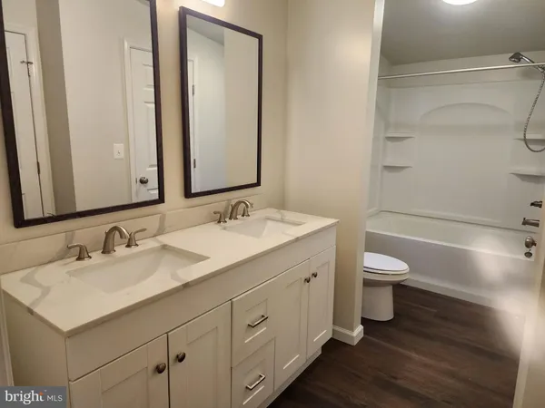 a bathroom with 2 sink and a mirror