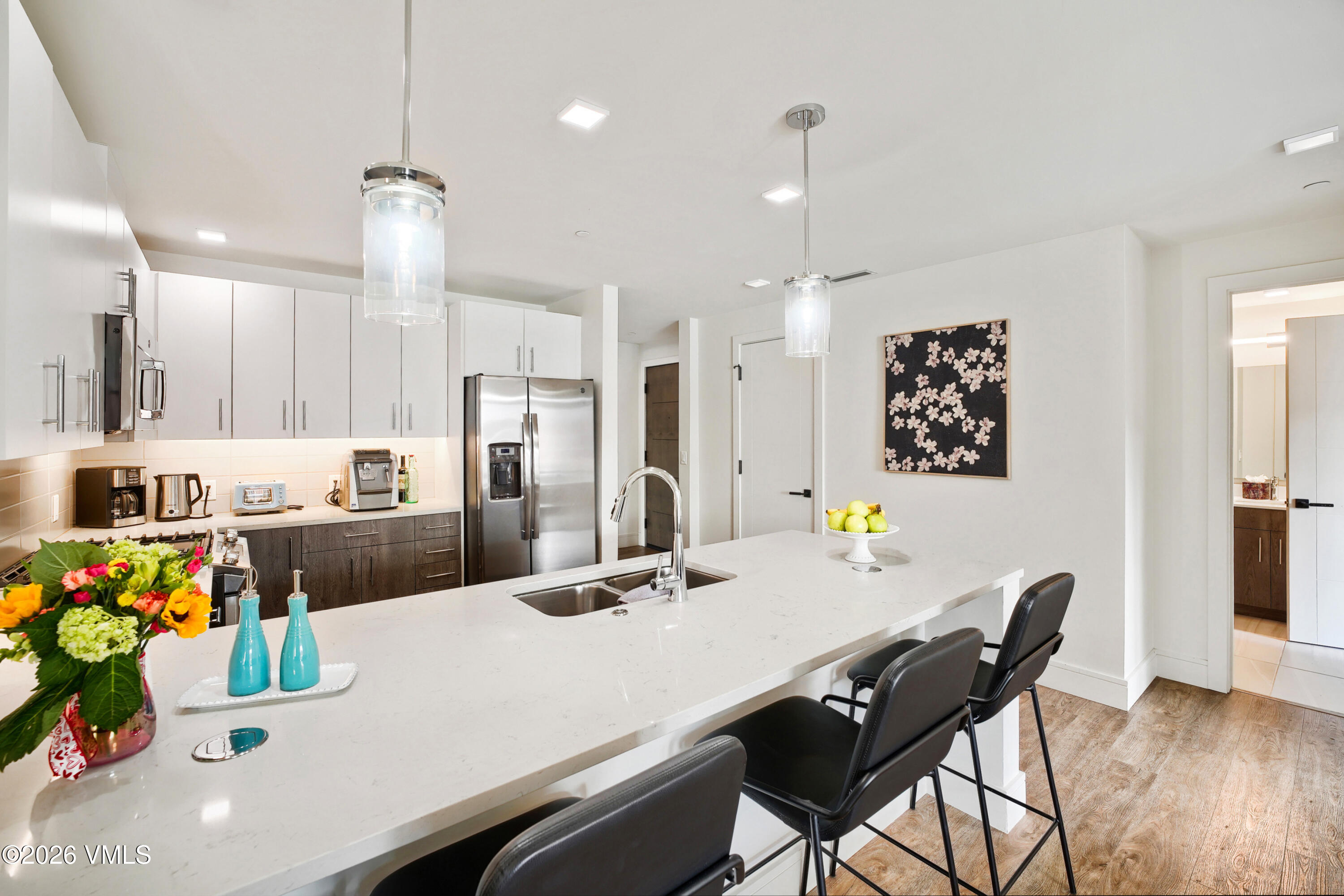430 South Frontage Road East, Unit RUE Vail, CO 81657 - Photo 11 of 24 a kitchen with a dining table chairs and refrigerator