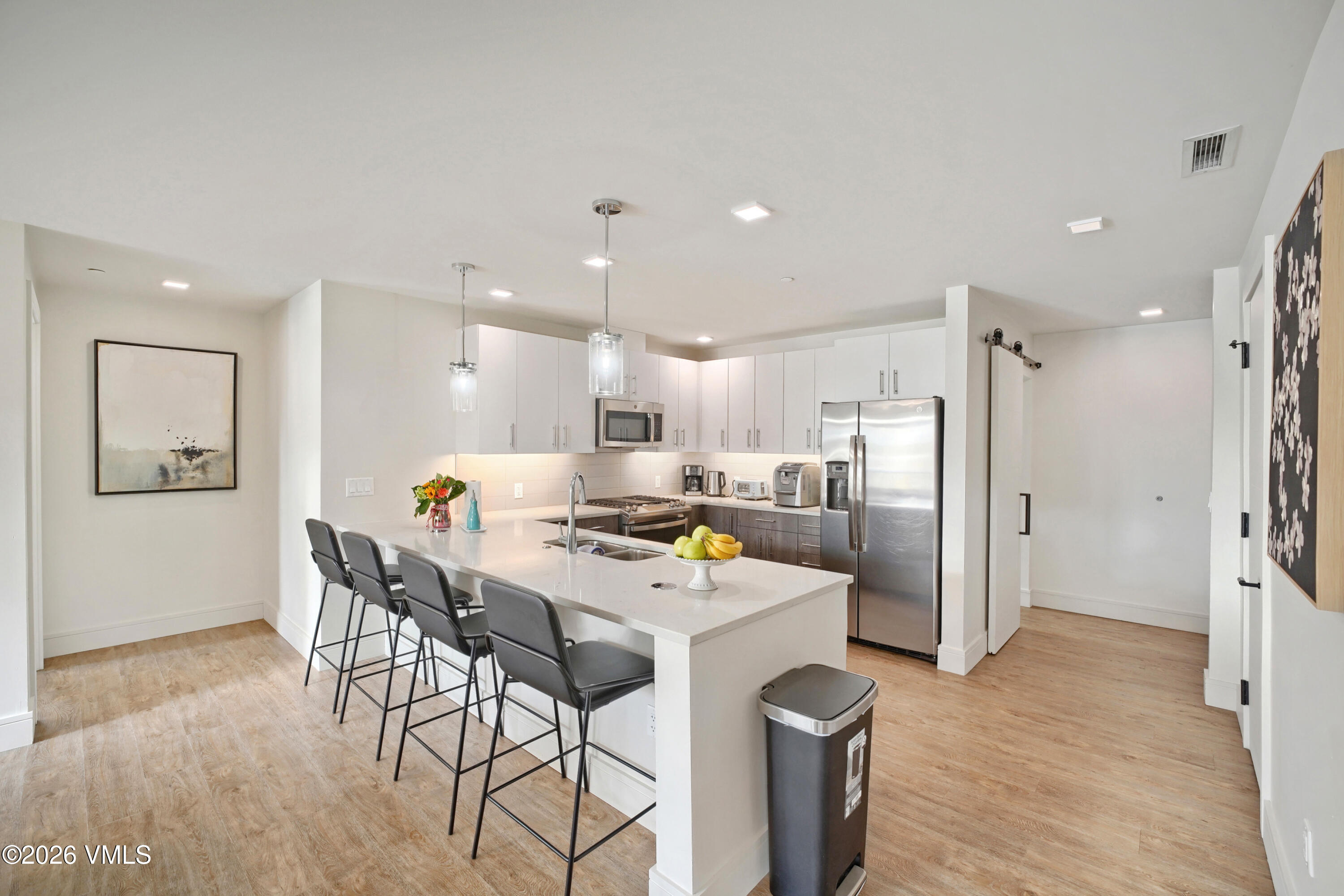430 South Frontage Road East, Unit RUE Vail, CO 81657 - Photo 13 of 24 a kitchen with a refrigerator a stove and a dining table