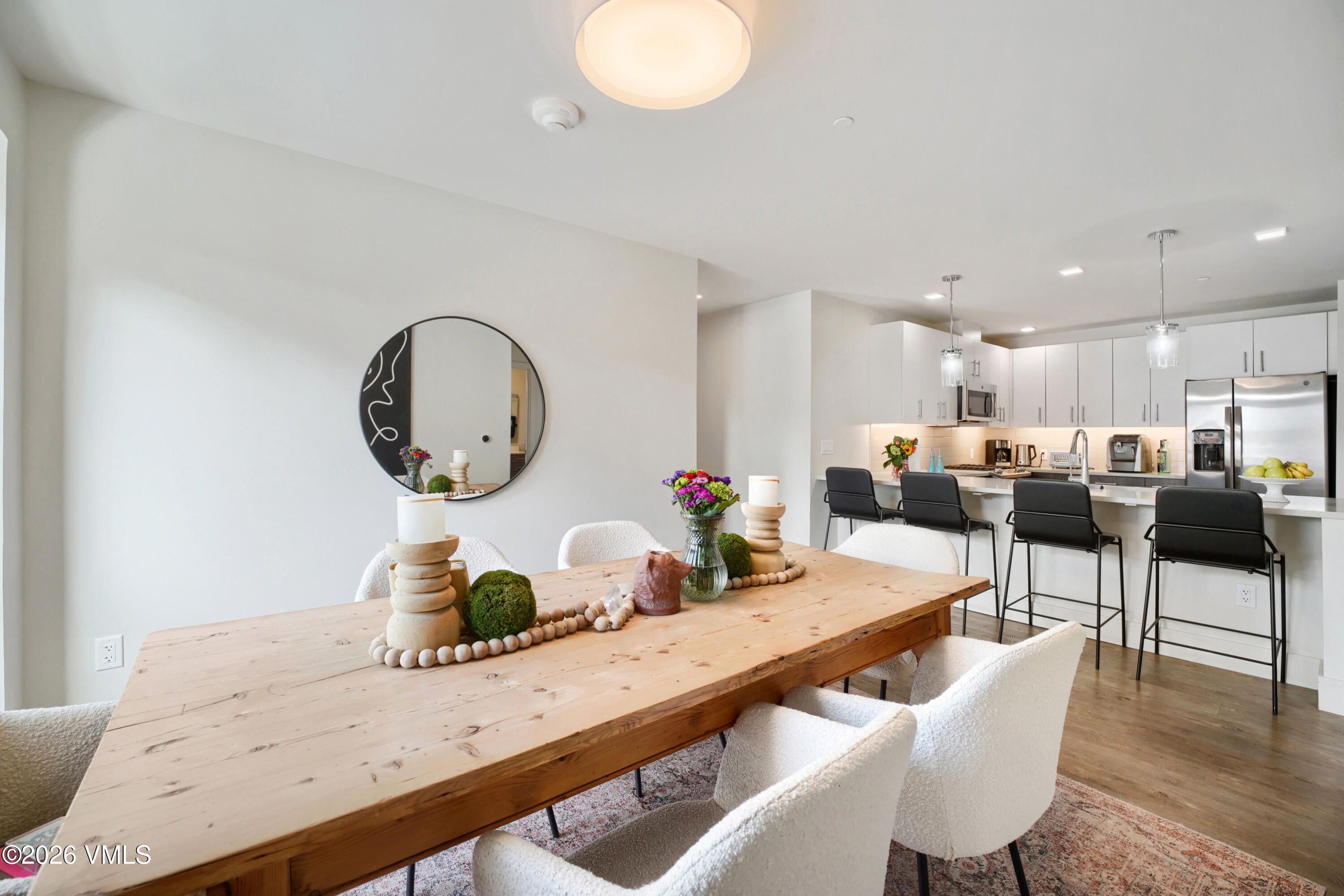 430 South Frontage Road East, Unit RUE Vail, CO 81657 - Photo 16 of 24 a dining room with wooden floor a rug and kitchen view