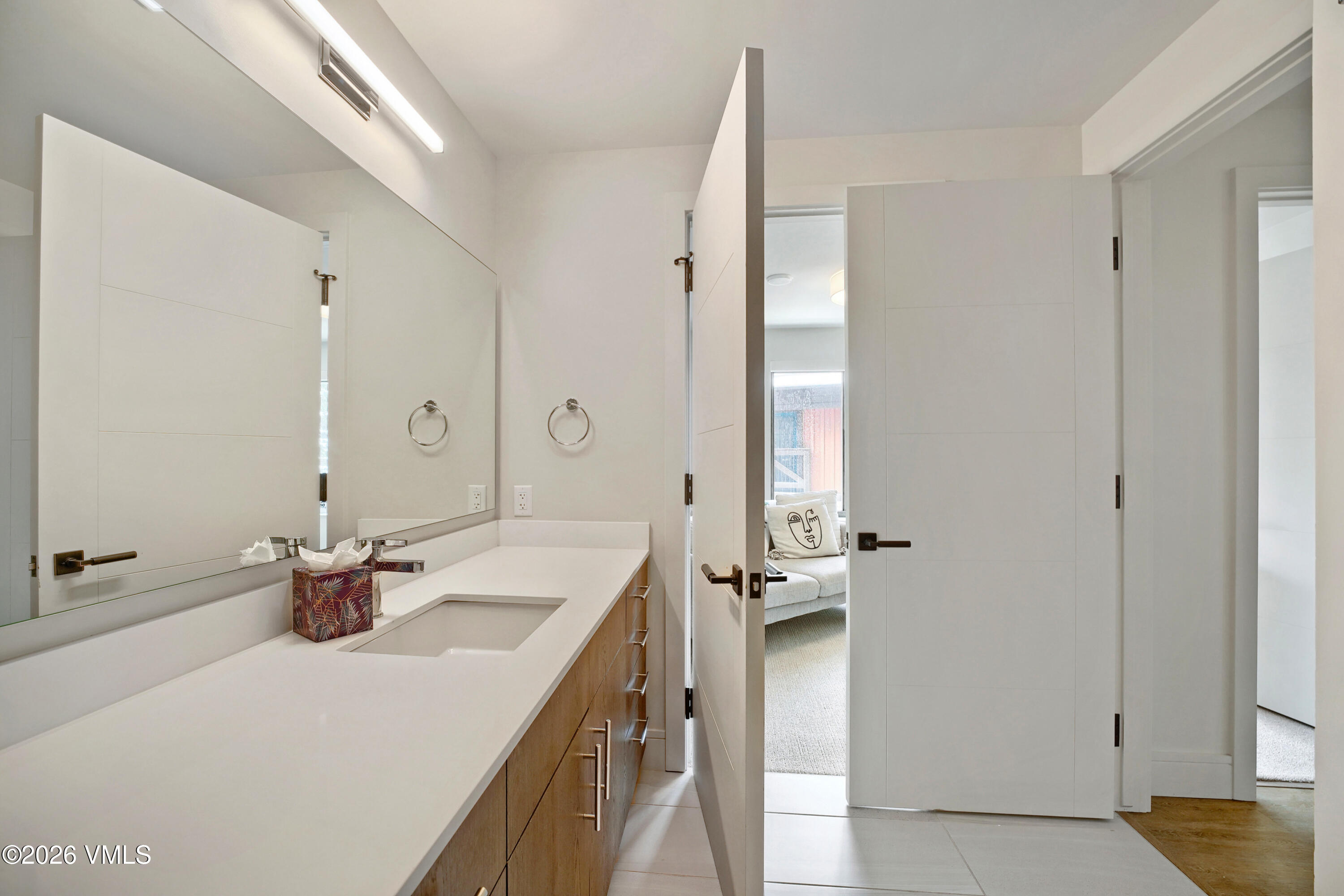 430 South Frontage Road East, Unit RUE Vail, CO 81657 - Photo 22 of 24 a bathroom with a sink a mirror and a shower