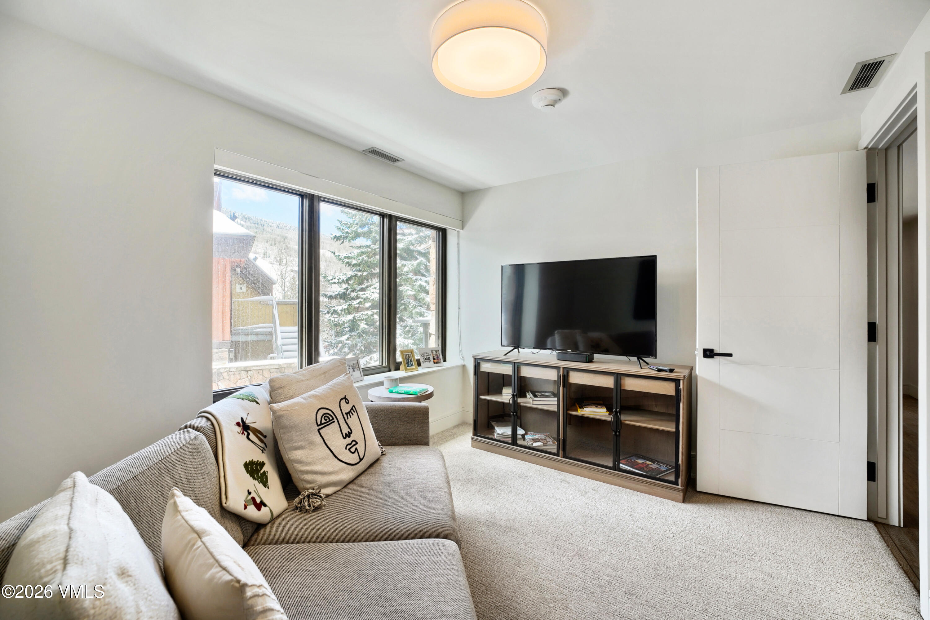 430 South Frontage Road East, Unit RUE Vail, CO 81657 - Photo 4 of 24 a living room with furniture and a flat screen tv