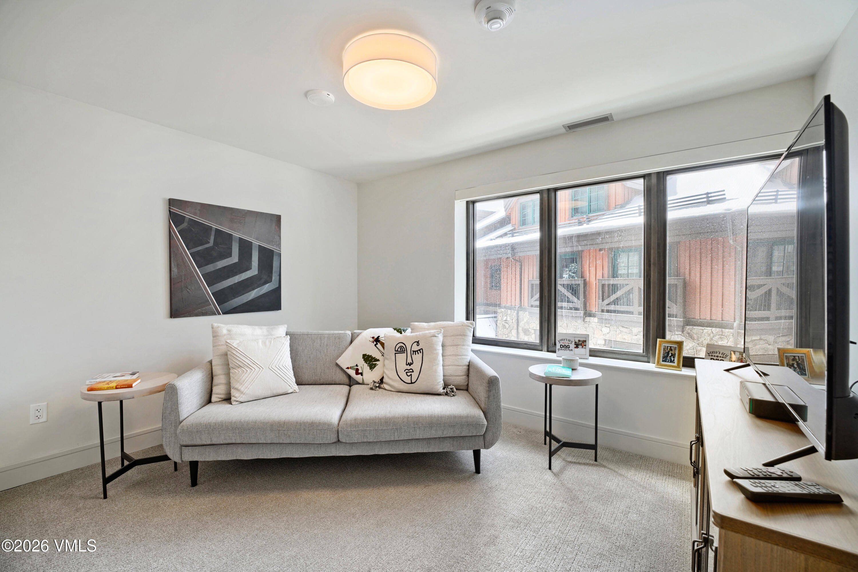430 South Frontage Road East, Unit RUE Vail, CO 81657 - Photo 6 of 24 a living room with furniture and large windows