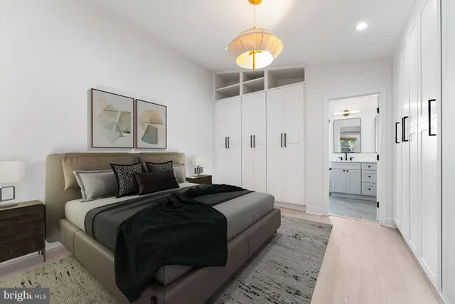 a bedroom with a bed and a chandelier