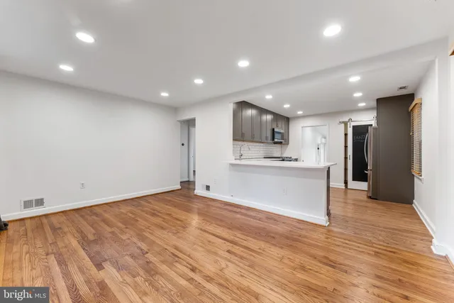 a view of kitchen with refrigerator a microwave and a sink