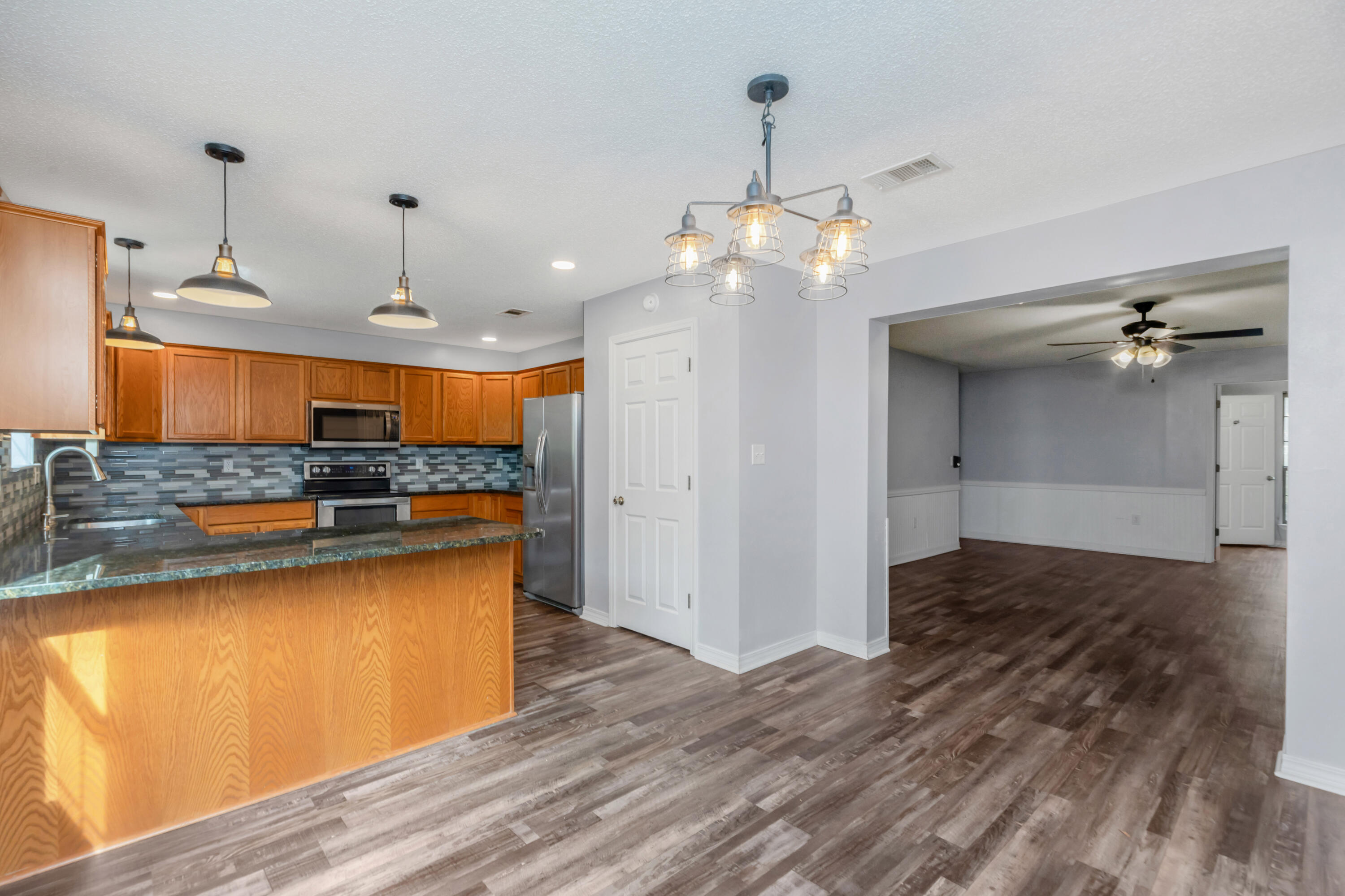 5825 Old Bethel Road Crestview, FL 32536 - Photo 13 of 44 a view of a kitchen counter space and wooden floor