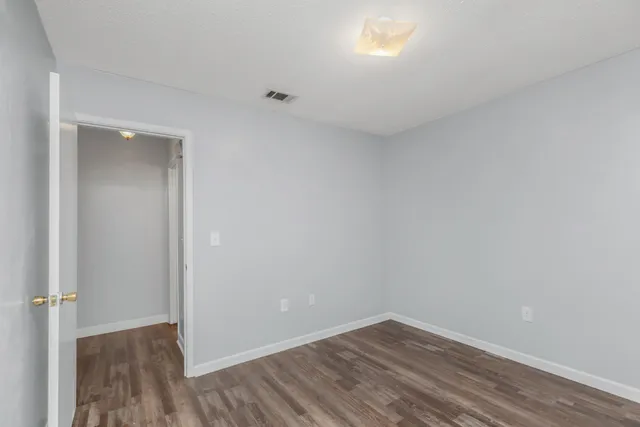 a view of an empty room and wooden floor