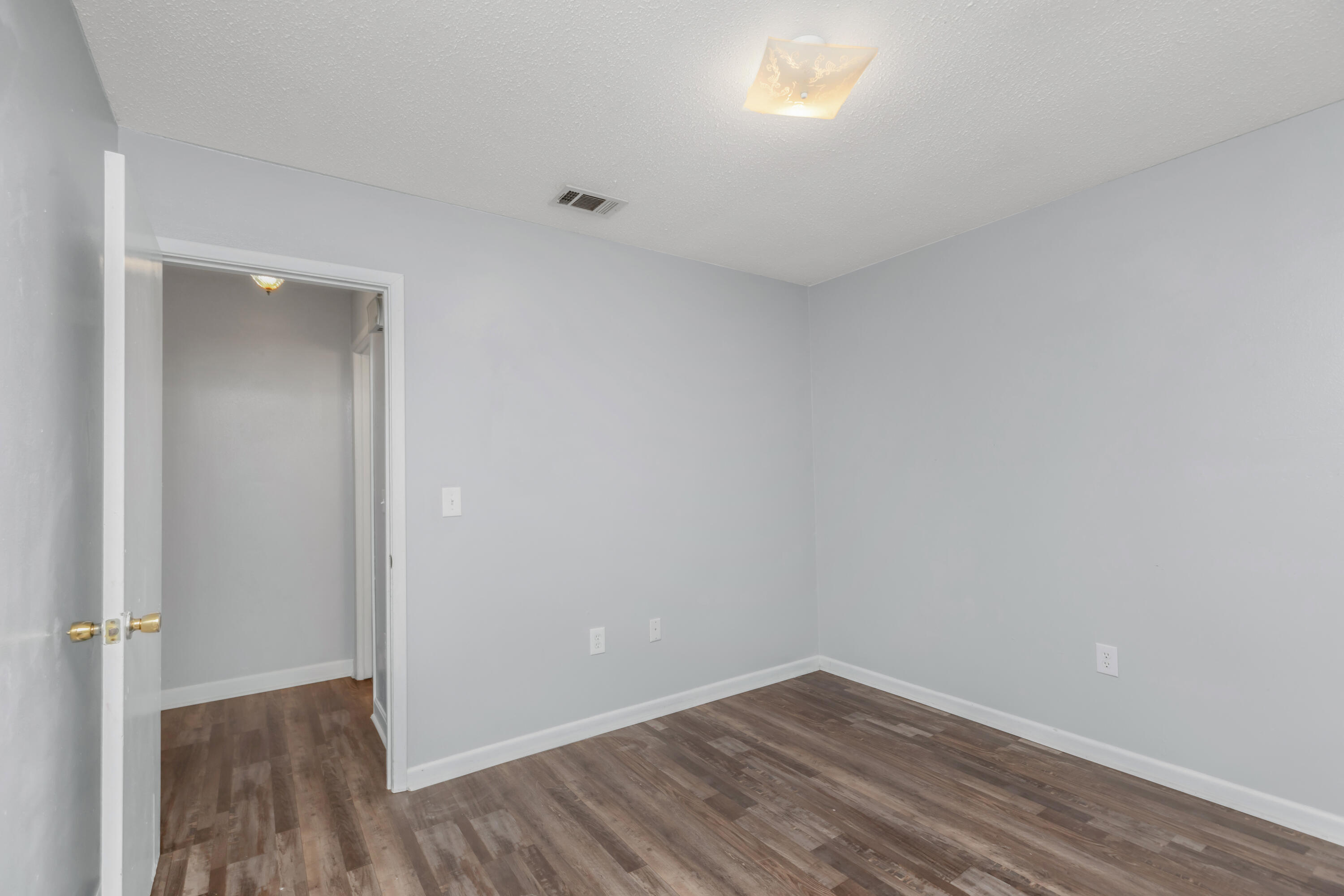 5825 Old Bethel Road Crestview, FL 32536 - Photo 19 of 44 a view of an empty room and wooden floor