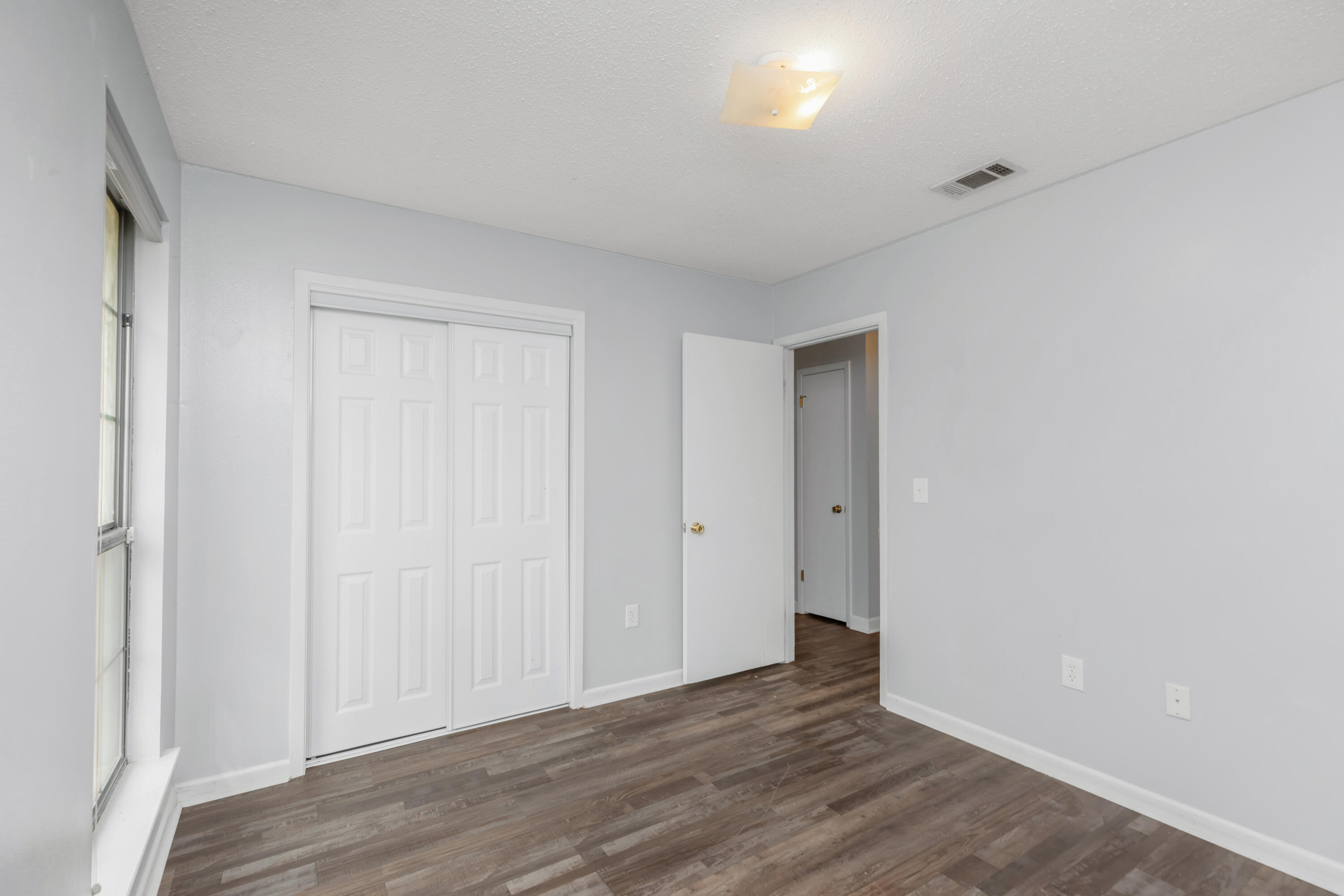 5825 Old Bethel Road Crestview, FL 32536 - Photo 20 of 44 a view of an empty room with wooden floor