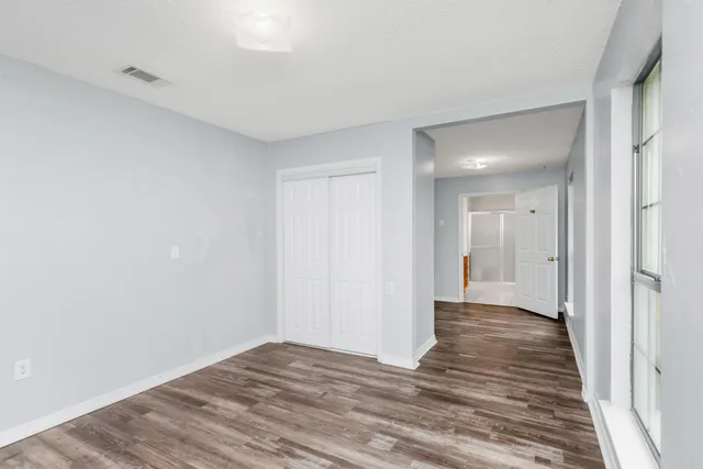 a view of a hallway with wooden floor