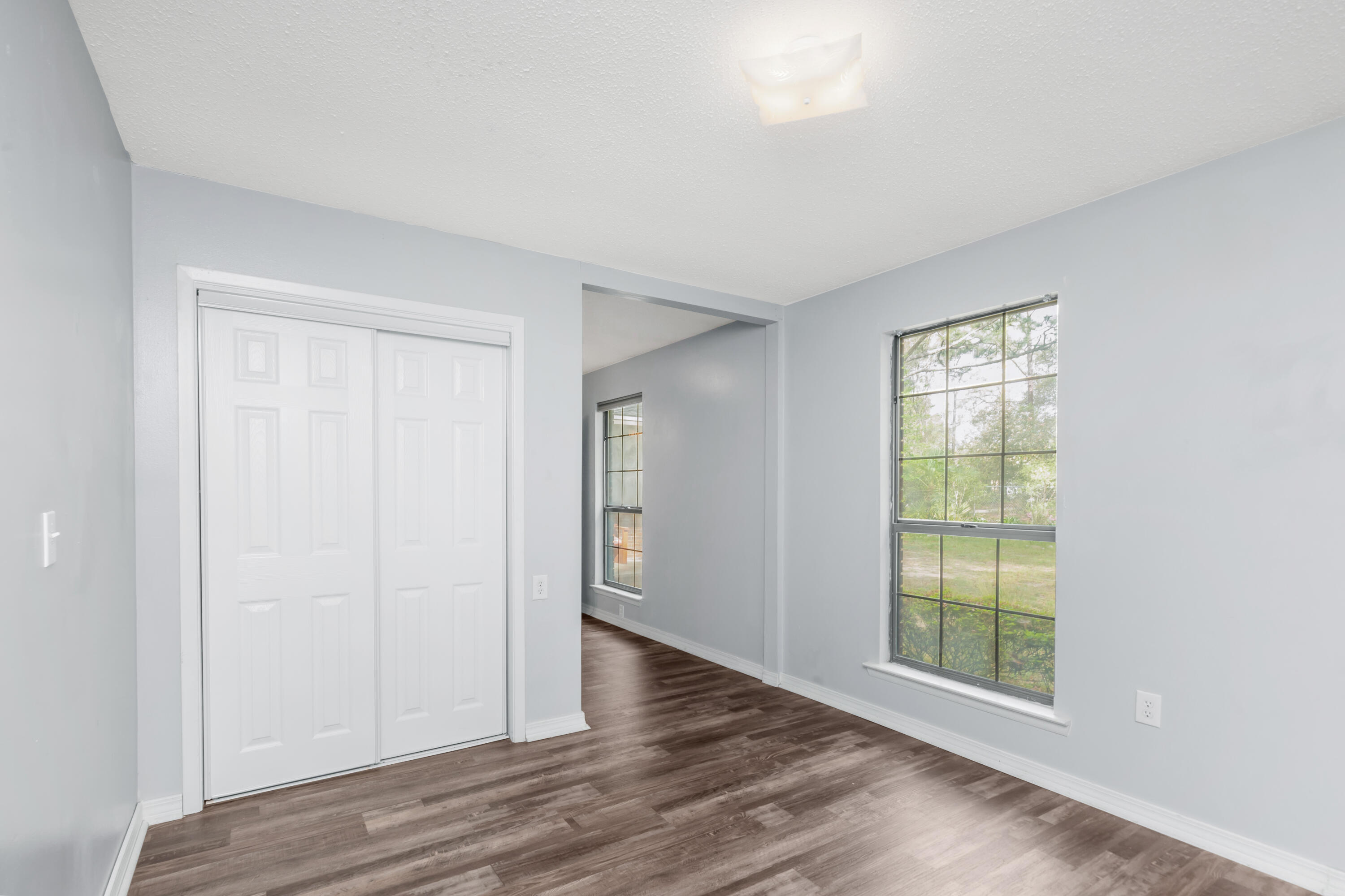 5825 Old Bethel Road Crestview, FL 32536 - Photo 25 of 44 an empty room with wooden floor and windows