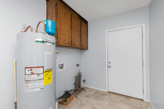 a view of storage and utility room with a window