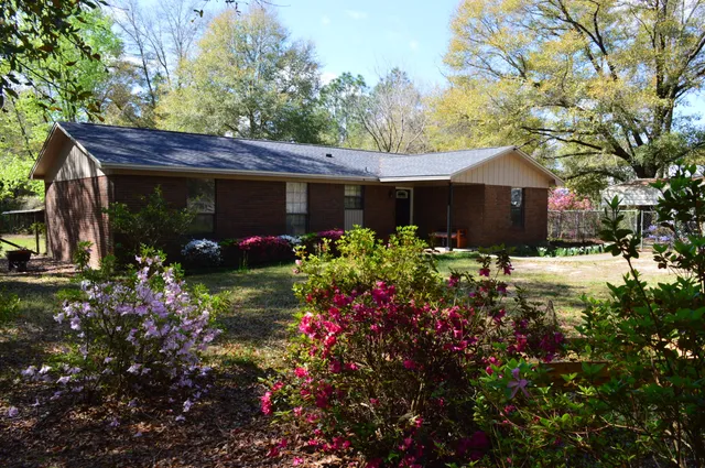 a view of a house with a yard and garage
