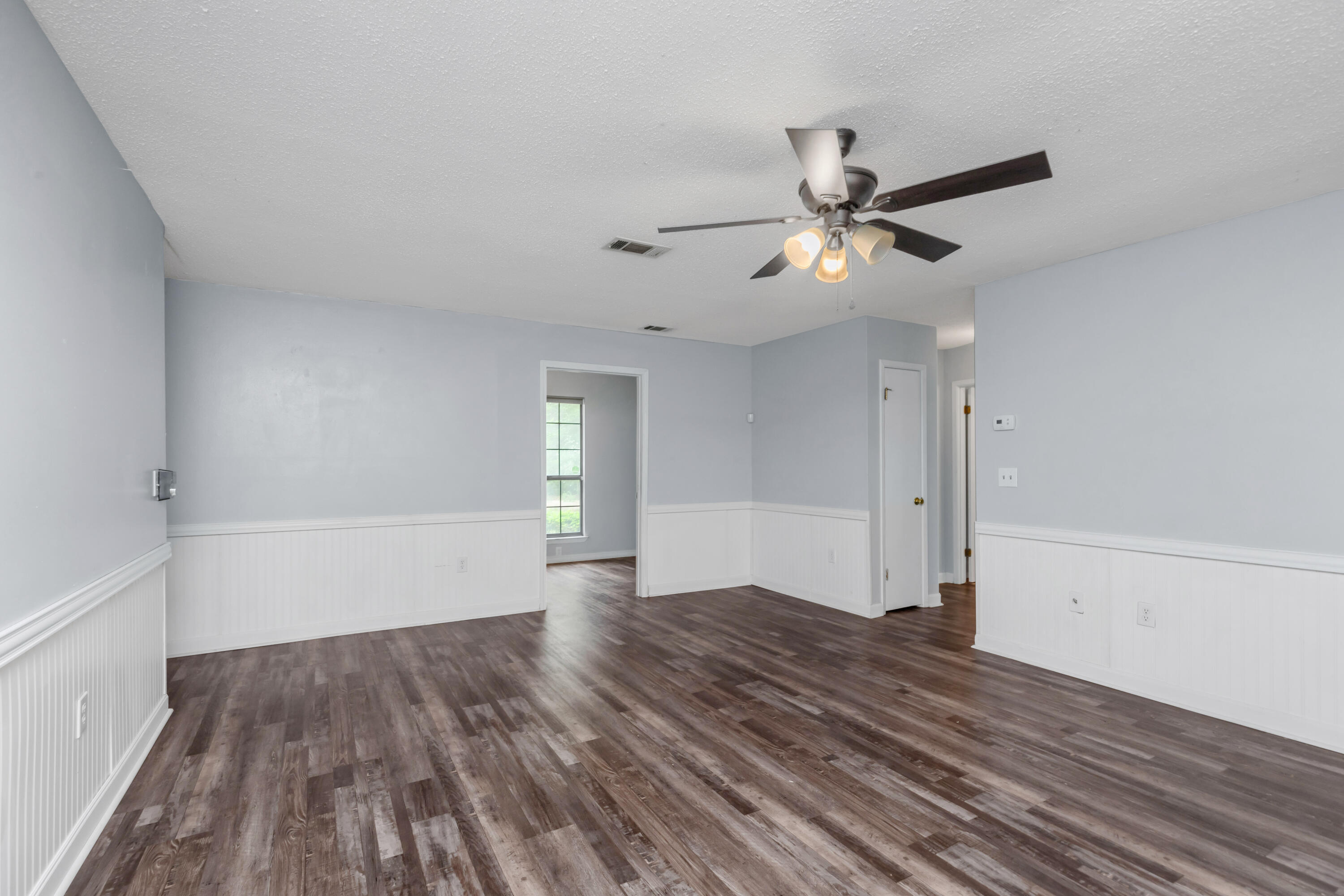 5825 Old Bethel Road Crestview, FL 32536 - Photo 5 of 44 a view of empty room with wooden floor and fan