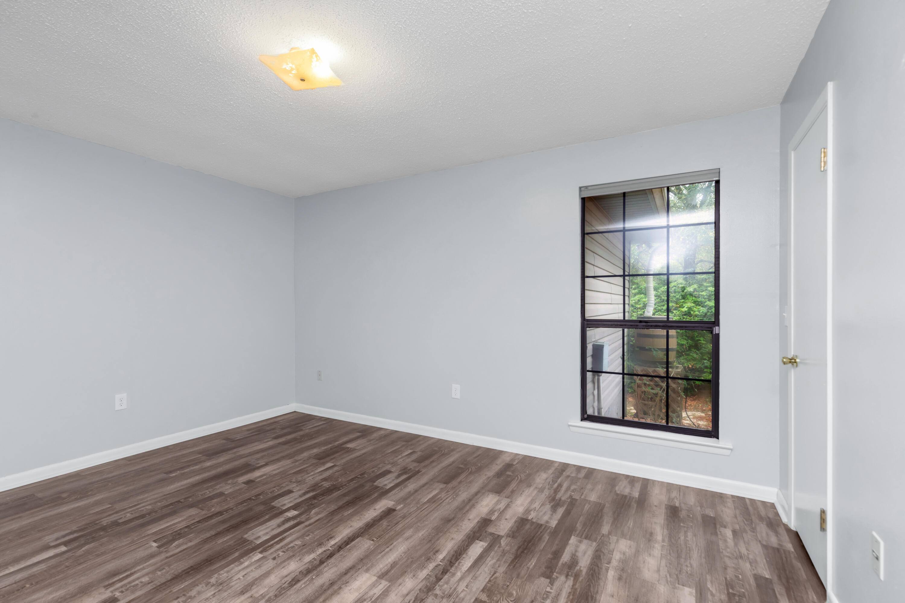 5825 Old Bethel Road Crestview, FL 32536 - Photo 8 of 44 wooden floor in an empty room with a window