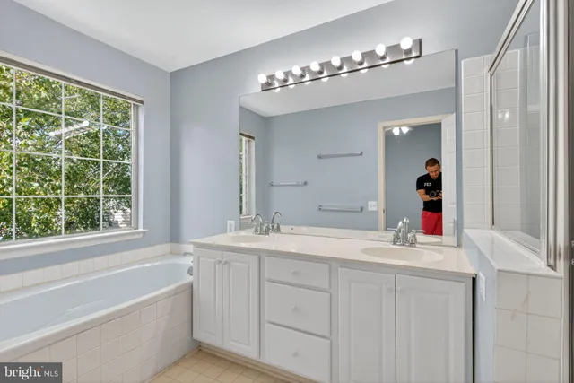 a bathroom with a double vanity sink and a mirror