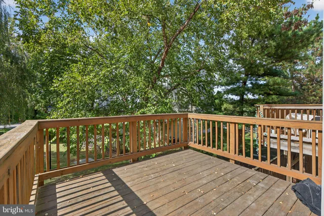 a balcony with wooden floor and fence