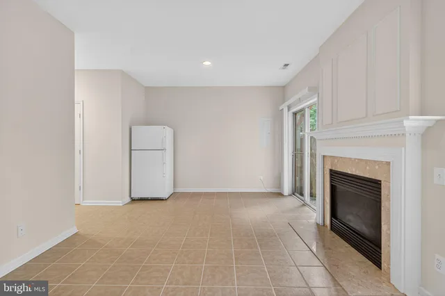 a view of empty room with fireplace