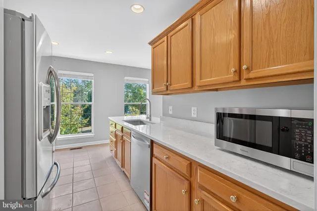 a kitchen with a sink and a stove top oven