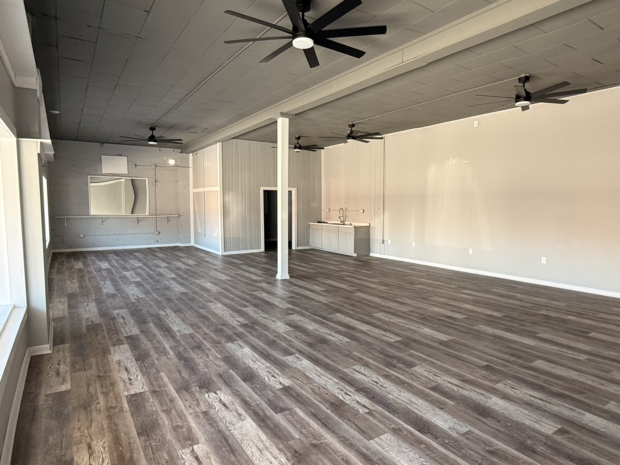 803 McArthur Street Manchester, TN 37355 - Photo 3 of 31 a view of a livingroom with a ceiling fan and wooden floor