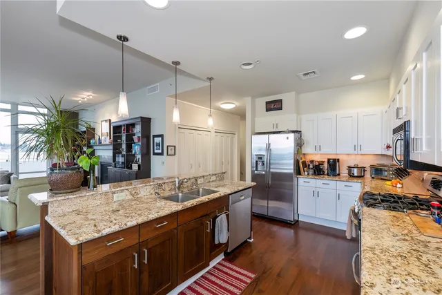a large kitchen with kitchen island a large island in the center