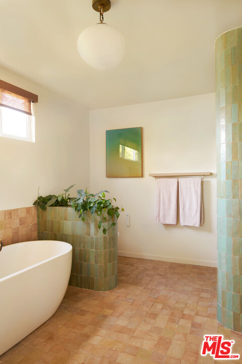 29500 Heathercliff Road, Unit 288 Malibu, CA 90265 - Photo 12 of 26 a bathroom with a bathtub and a shower