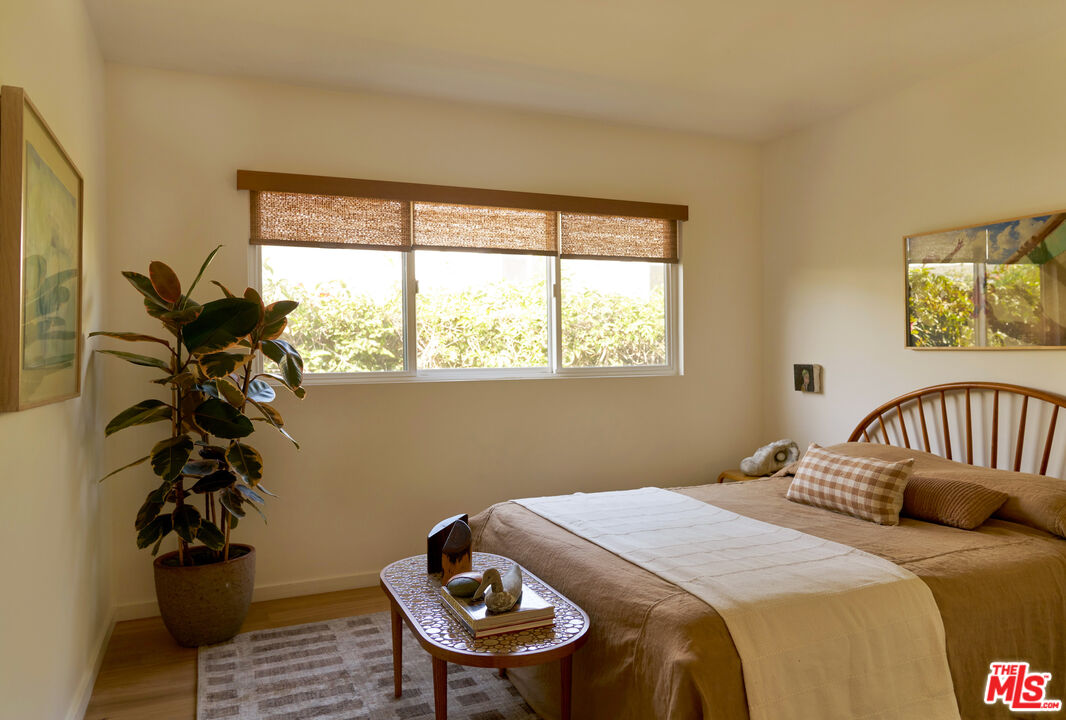29500 Heathercliff Road, Unit 288 Malibu, CA 90265 - Photo 13 of 26 a bedroom with a bed and a potted plant