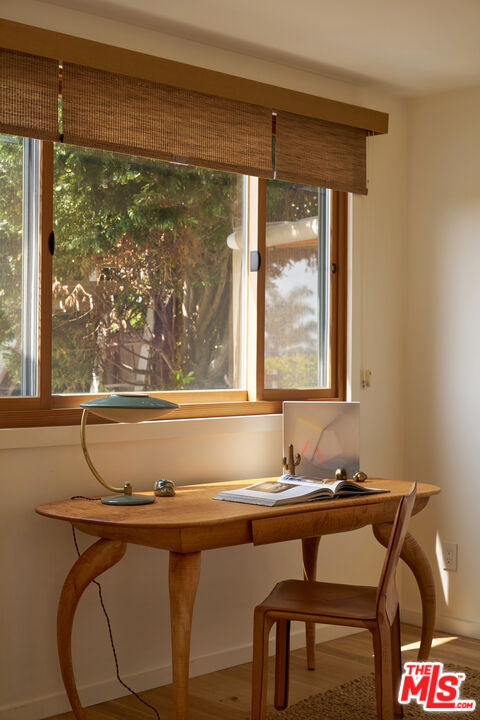 29500 Heathercliff Road, Unit 288 Malibu, CA 90265 - Photo 16 of 26 a room with a table chairs and wooden floor